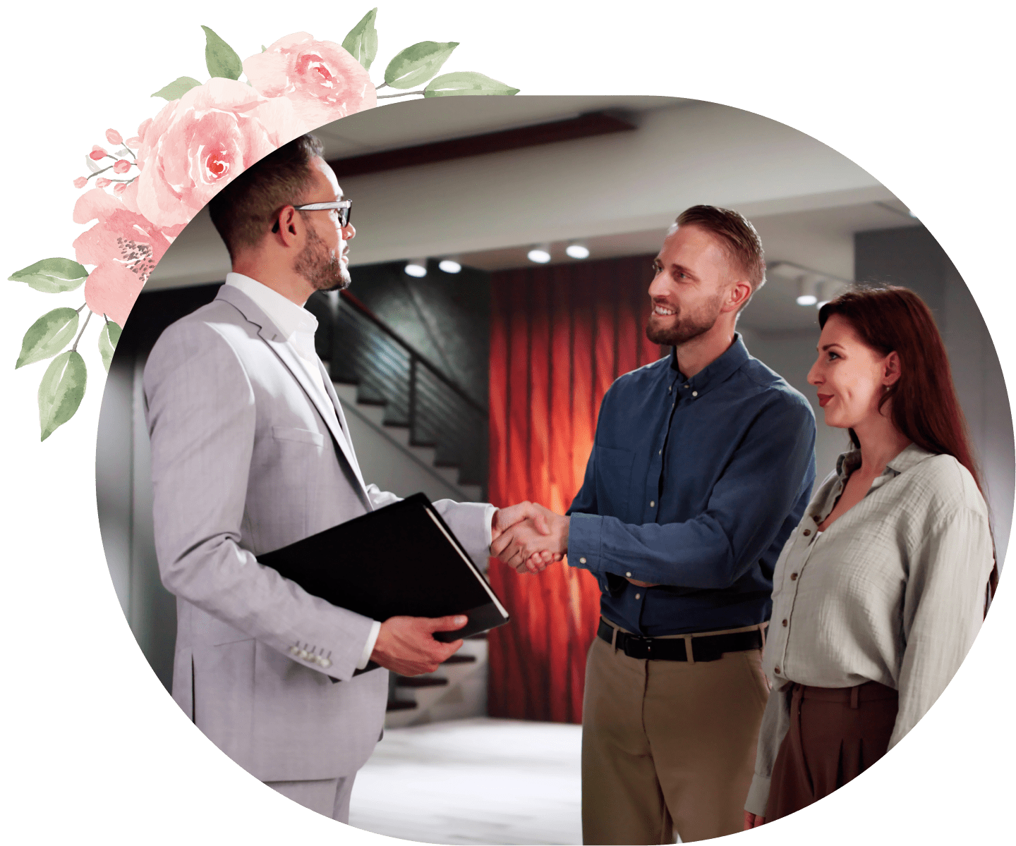 Real estate agent shaking hands with clients.