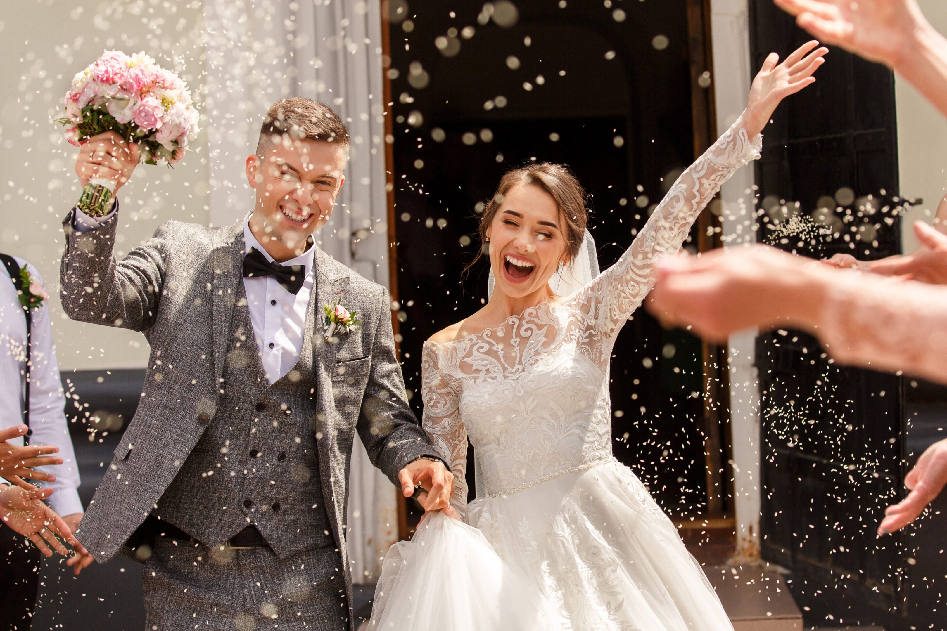 Happy newlyweds showered with confetti.
