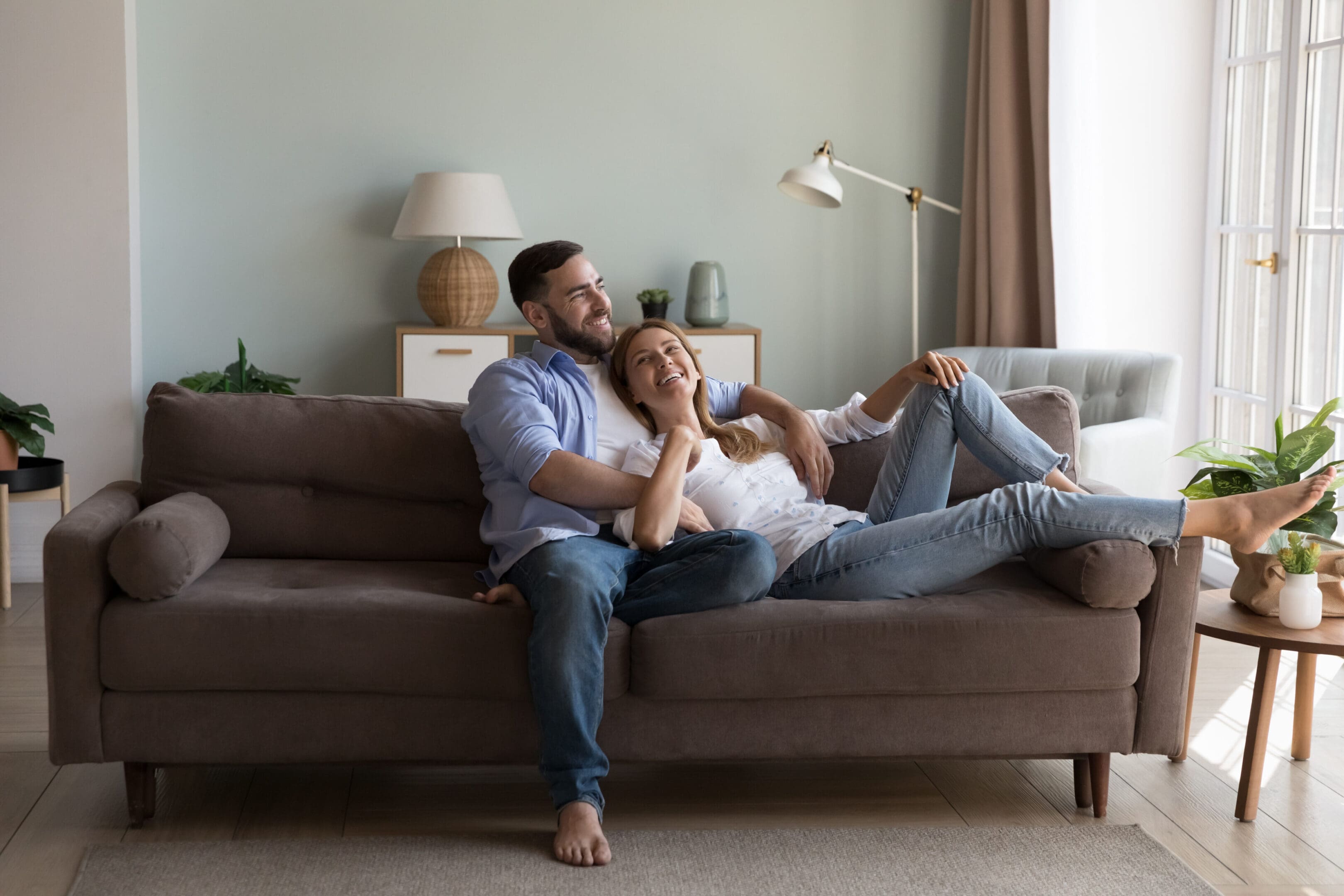 Couple in love enjoy conversation resting on sofa at home Happy couple relaxing on a couch.